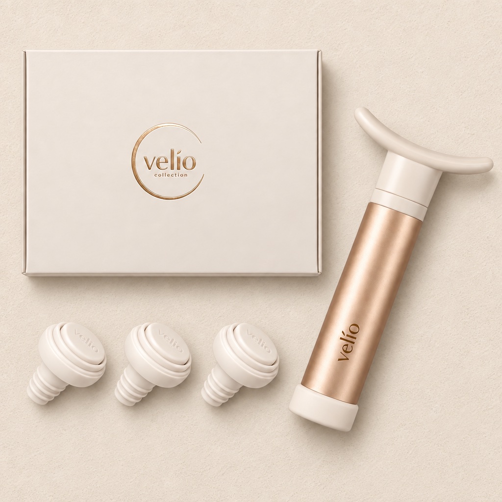 Closed Velio gift box seen from above, with the champagne-gold pump and three stoppers beside it
